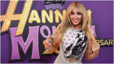‘She got the money and lived next door’: Miley Cyrus jokes ‘superfan’ Alex Cooper is ‘kinda creepy’ at Hannah Montana 20th anniversary special.